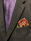 Folded pocket square with roulette wheel showing out of suit jacket breast pocket