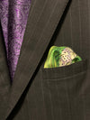 Folded pocket square with dice showing out of suit jacket breast pocket